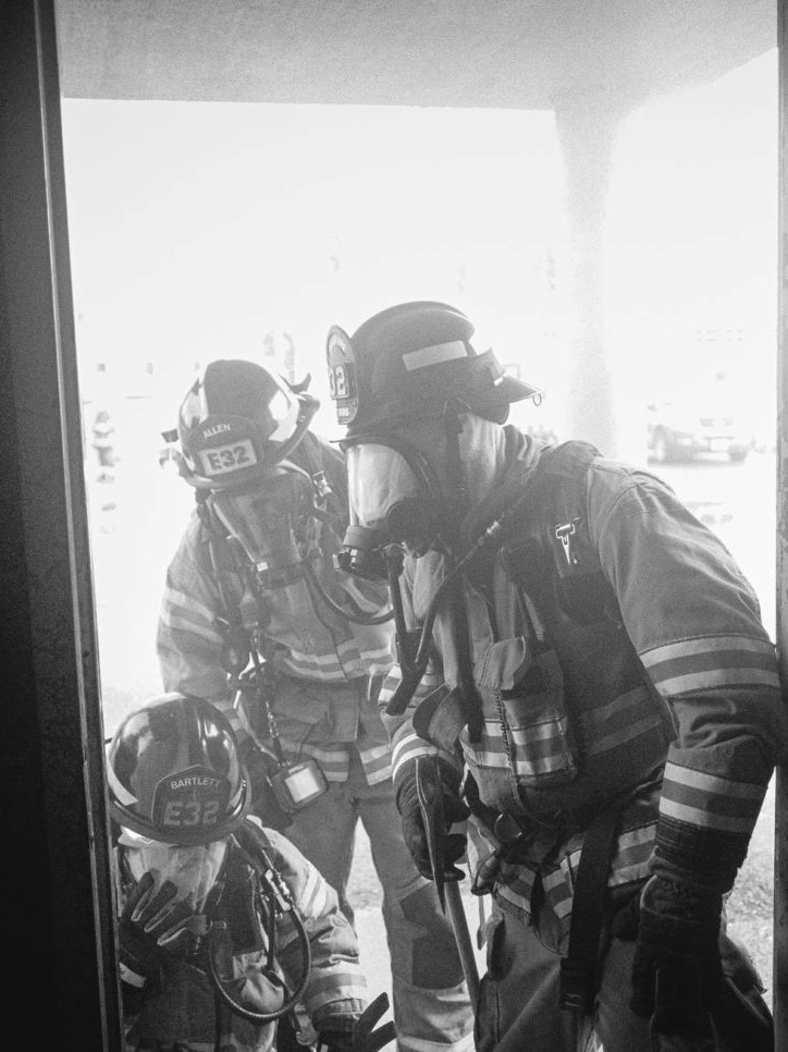 Firefighters from the fire department, standing in a doorway, ready to provide their service.