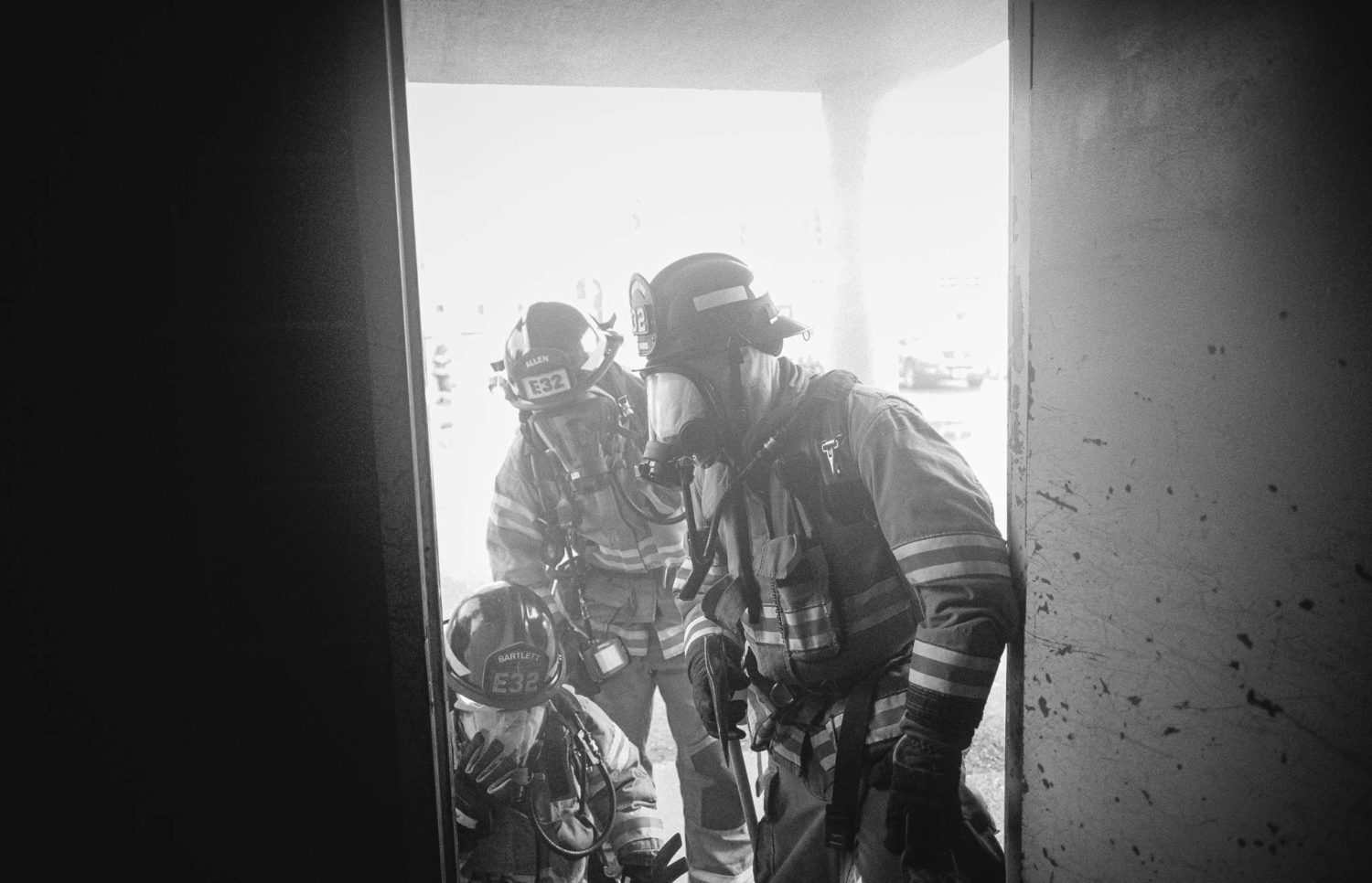 Firefighters from the fire department, standing in a doorway, ready to provide their service.