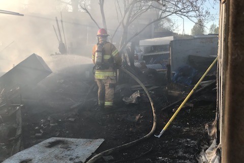 A firefighter from Valley Regional Fire Authority is working on a house fire.