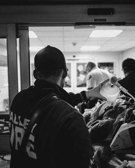 A black and white photo of a group of people standing in a hallway, symbolizing the dedication and service of Valley Regional Fire Authority personnel.