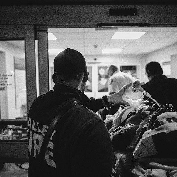 A black and white photo of a group of people standing in a hallway, symbolizing the dedication and service of Valley Regional Fire Authority personnel.