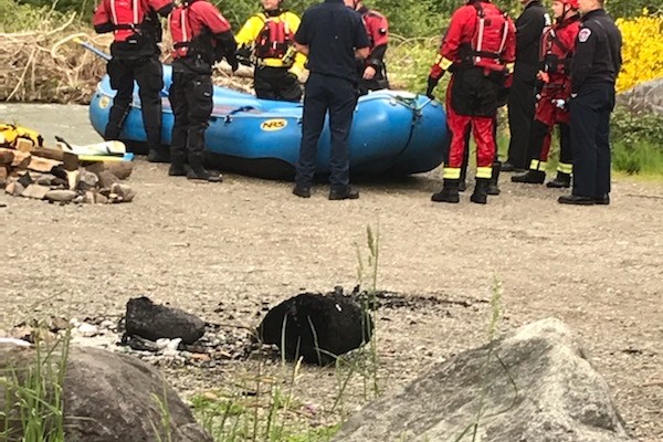 A group of firefighters from Valley Regional Fire Authority standing around a raft in the woods, providing their service.