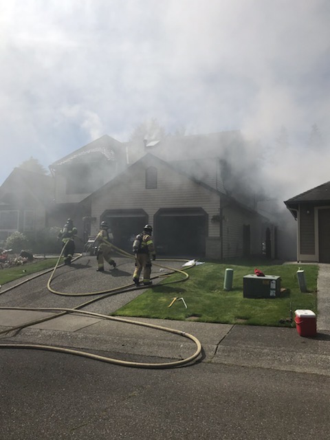 A Valley Regional Fire Authority firefighter is rescuing inhabitants from a house fire.