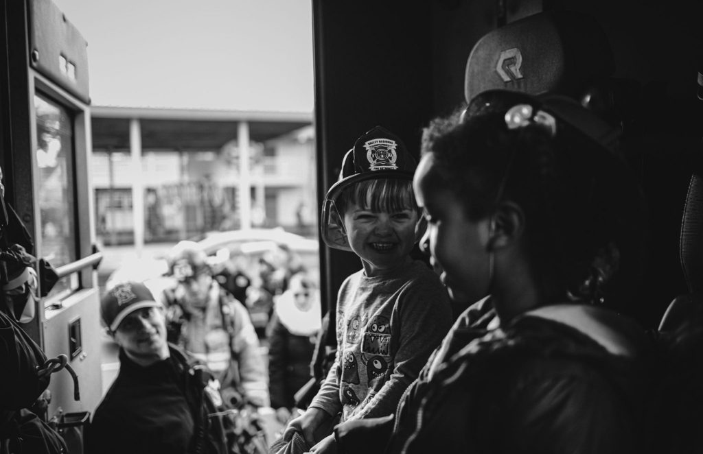 A black and white photo of a group of people on a rescue bus.