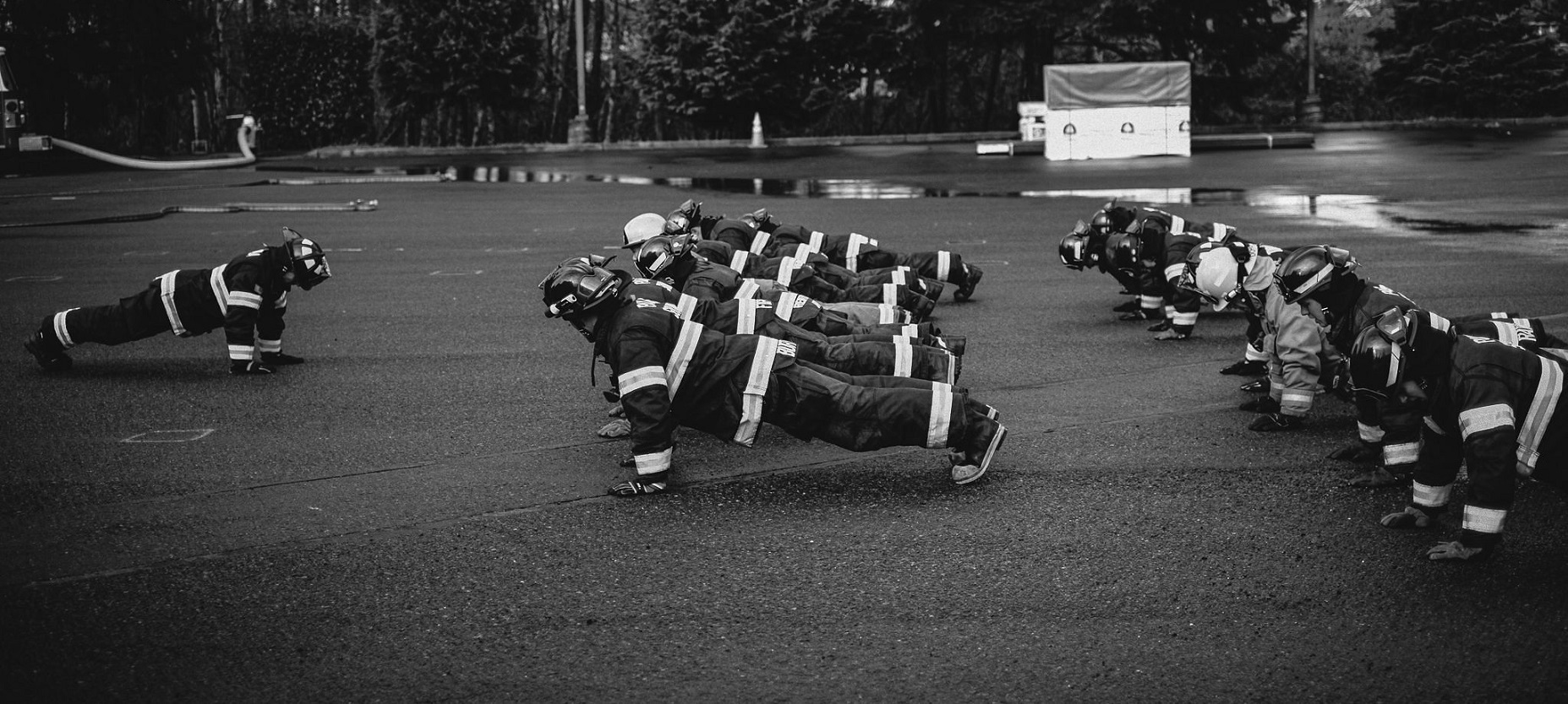 A black and white photo of a group of fire fighters from Valley Regional Fire Authority in action, providing rescue services.