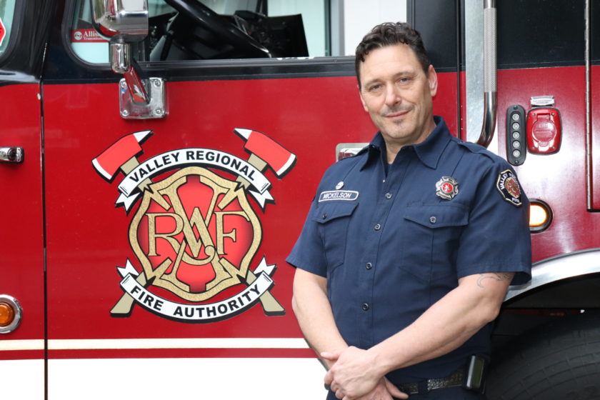 A firefighter from Valley Regional Fire Authority standing in front of a fire truck.