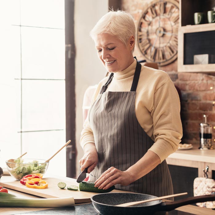 Woman smiling and cooking