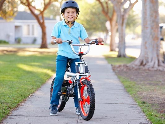 Child on bike wearing a helmet