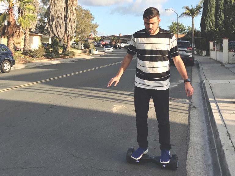 A firefighter riding a hoverboard on a street.