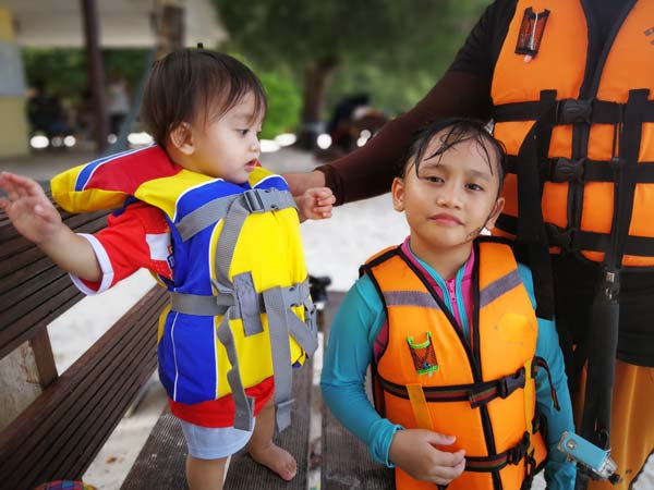 Two children and mom wearing a life jacket