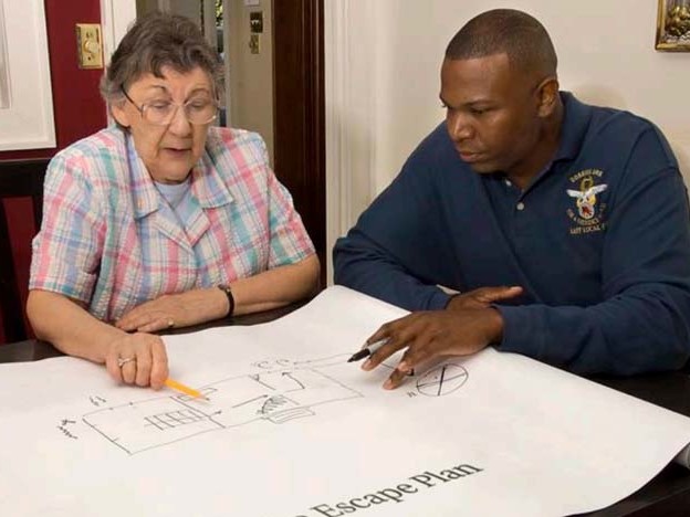 Old woman putting together a home fire escape plan