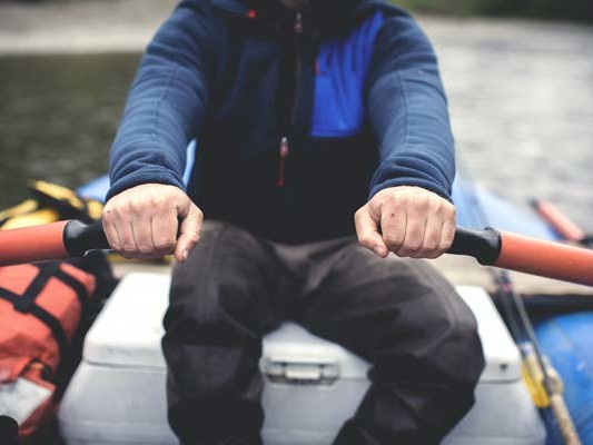 Man rowing a river boat