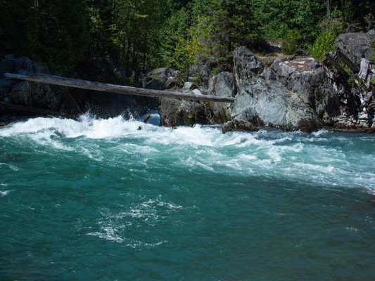 Blue and green river rapids through cliffs