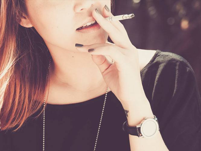 Young woman smoking cigarette