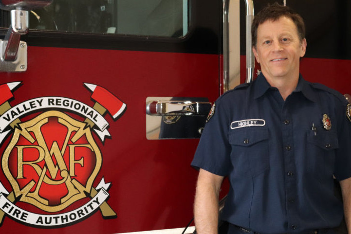 A Valley Regional Fire Authority firefighter standing in front of a fire truck.