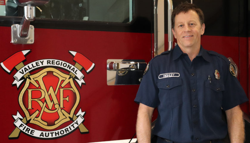 A Valley Regional Fire Authority firefighter standing in front of a fire truck.