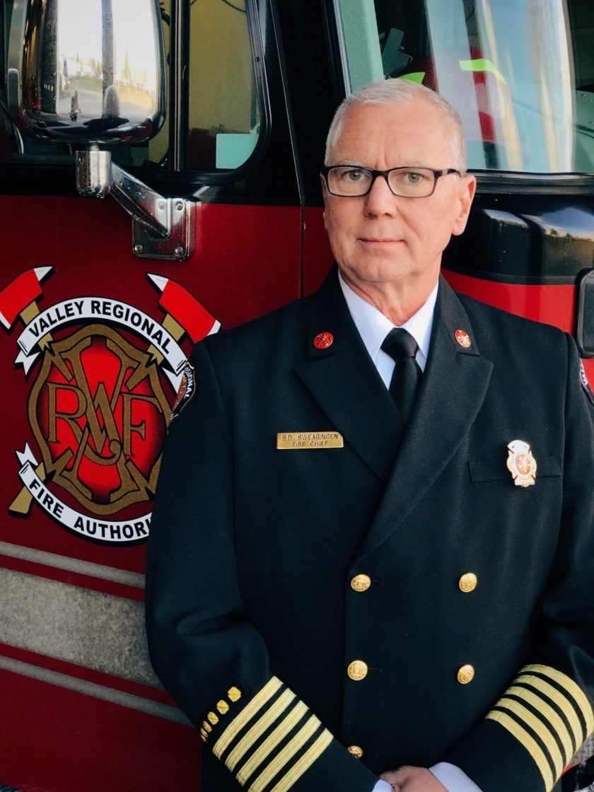 A Valley Regional Fire Authority firefighter standing in front of a fire truck.