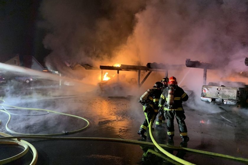 A firefighter from Valley Regional Fire Authority is bravely battling a fire at night.