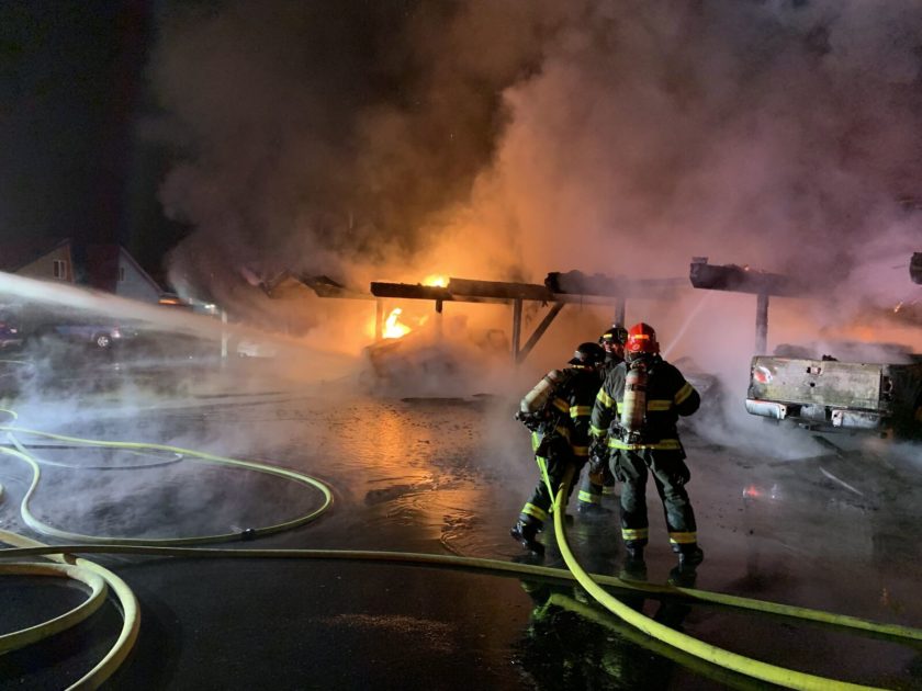 A firefighter from Valley Regional Fire Authority is bravely battling a fire at night.