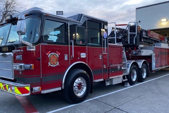 A red fire truck from Valley Regional Fire Authority parked in front of a building.