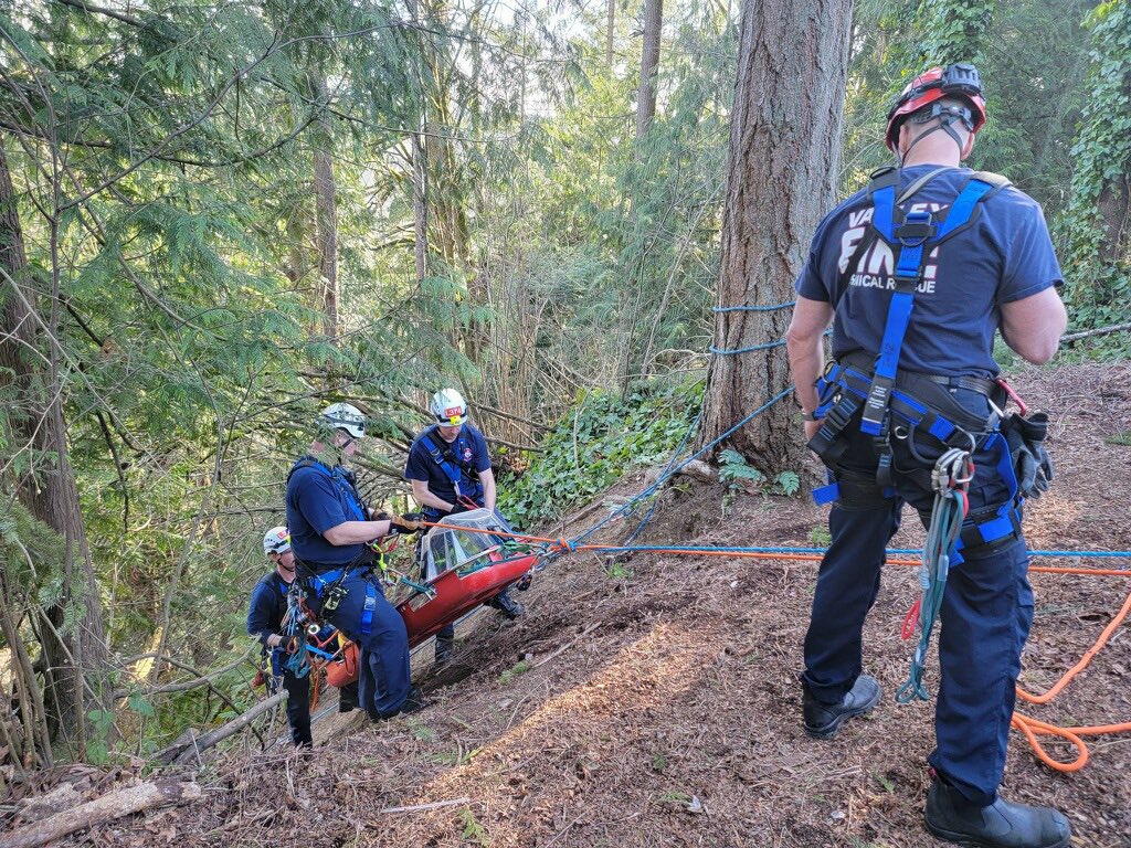 A group of Valley Regional Fire Authority firefighters are working on a trail in the woods to provide rescue service.