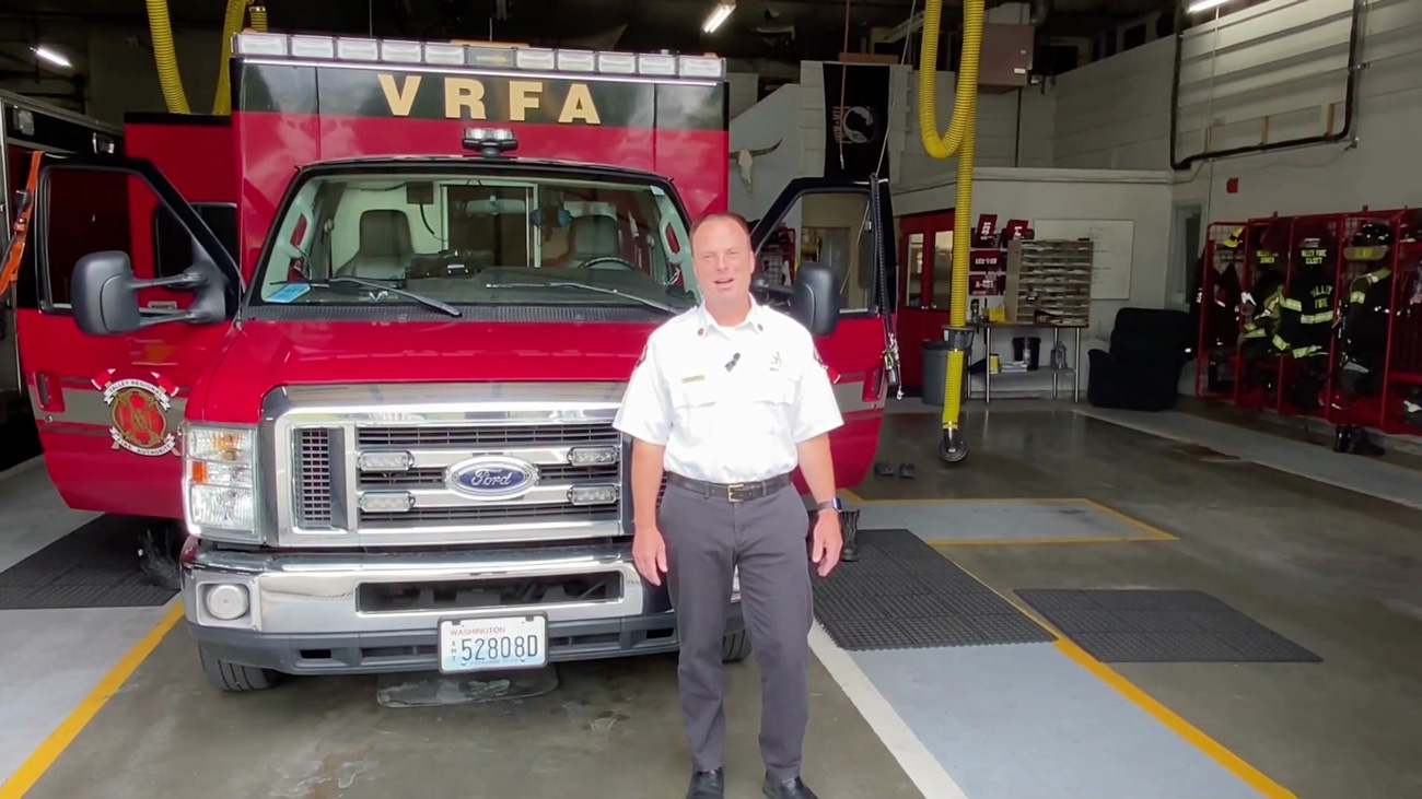 Fire chief in front of fire engine