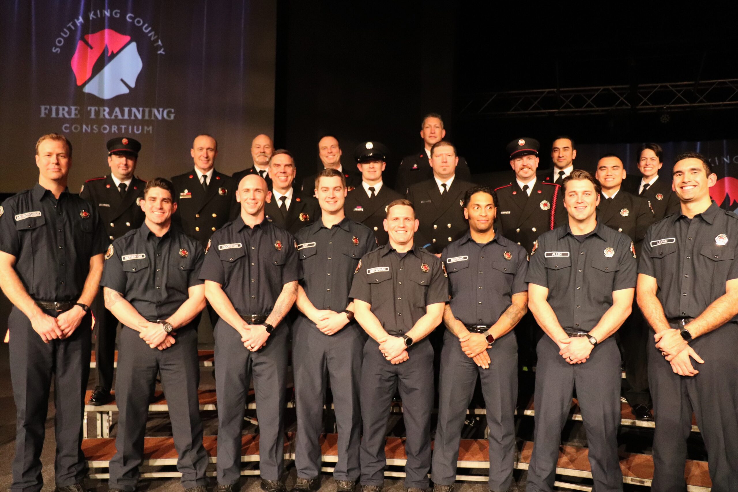 A group of firefighters posing for a photo.