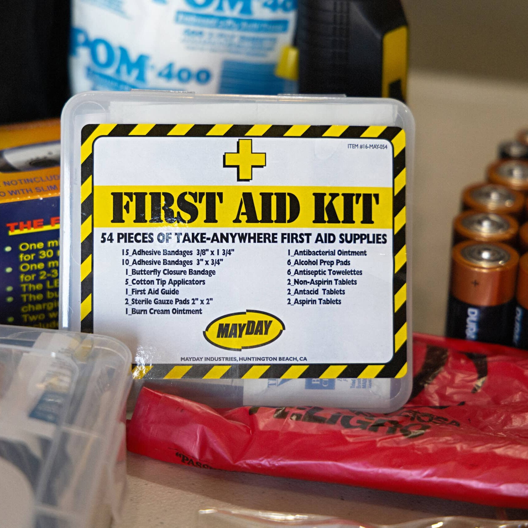 First aid kit surrounded by other emergency supplies