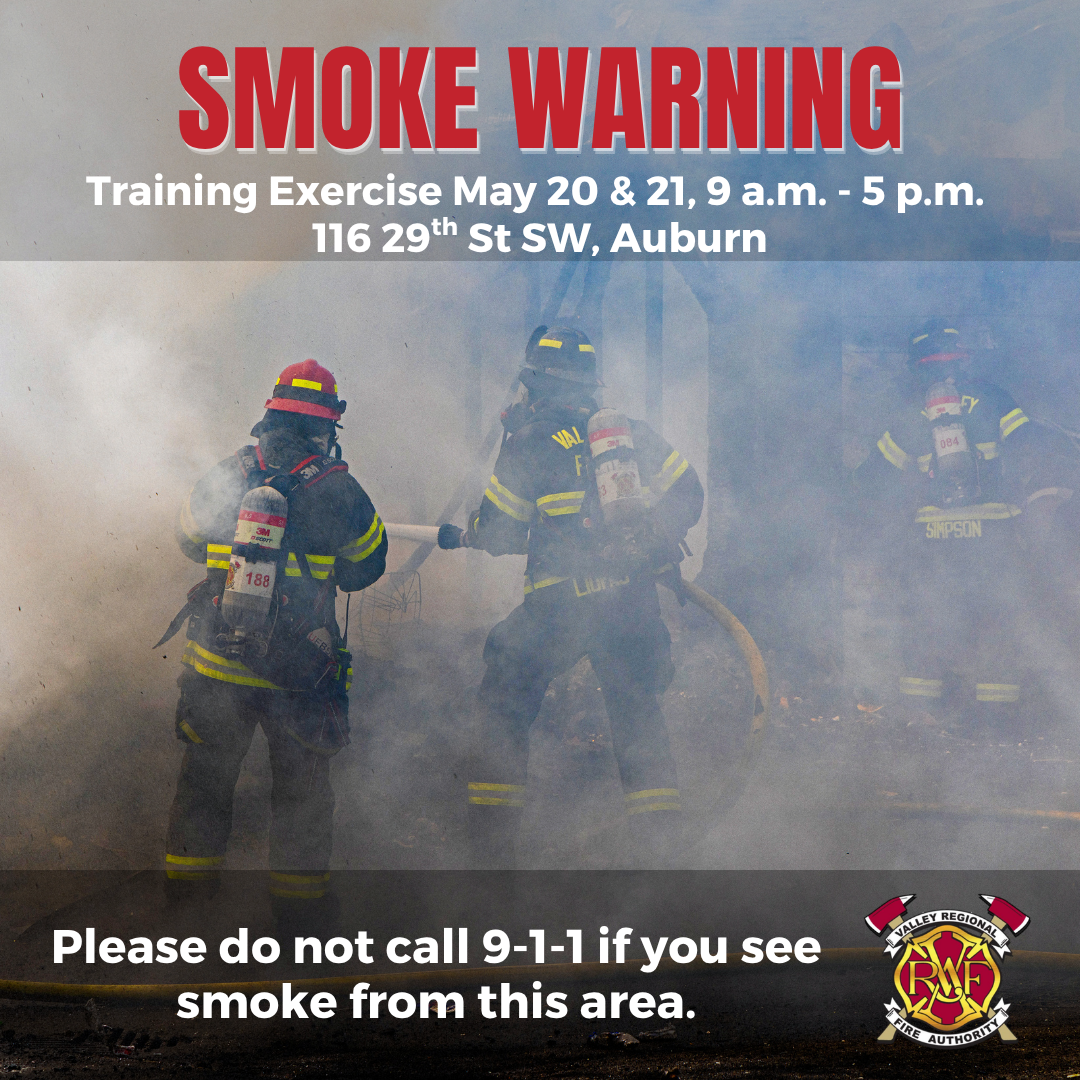 Three firefighters in full gear work in thick smoke during Live Fire Training, part of the King County Fire Training event. Smoke warning and caution about calling 9-1-1 are displayed, with event details in Auburn, WA.